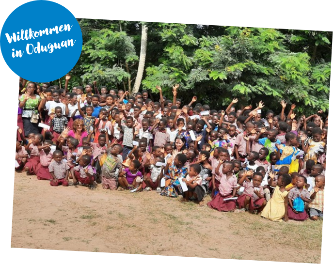 Großes Gruppenfoto mit SchülerInnen und LehrerInnen im Dorf Oduguan.